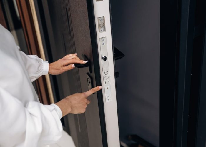 Woman's,Hand,Interacts,With,A,Modern,Door,Lock,Control,Panel,