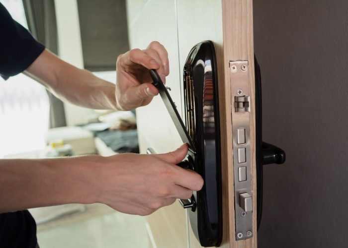 A,Technician,Installs,A,Modern,Smart,Door,Lock,On,The