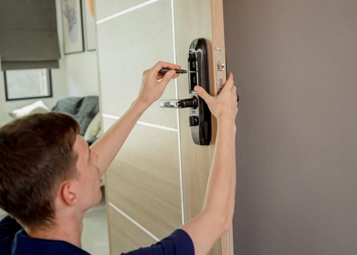 A,Technician,Installs,A,Modern,Smart,Door,Lock,On,The
